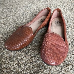 Brown woven flats.